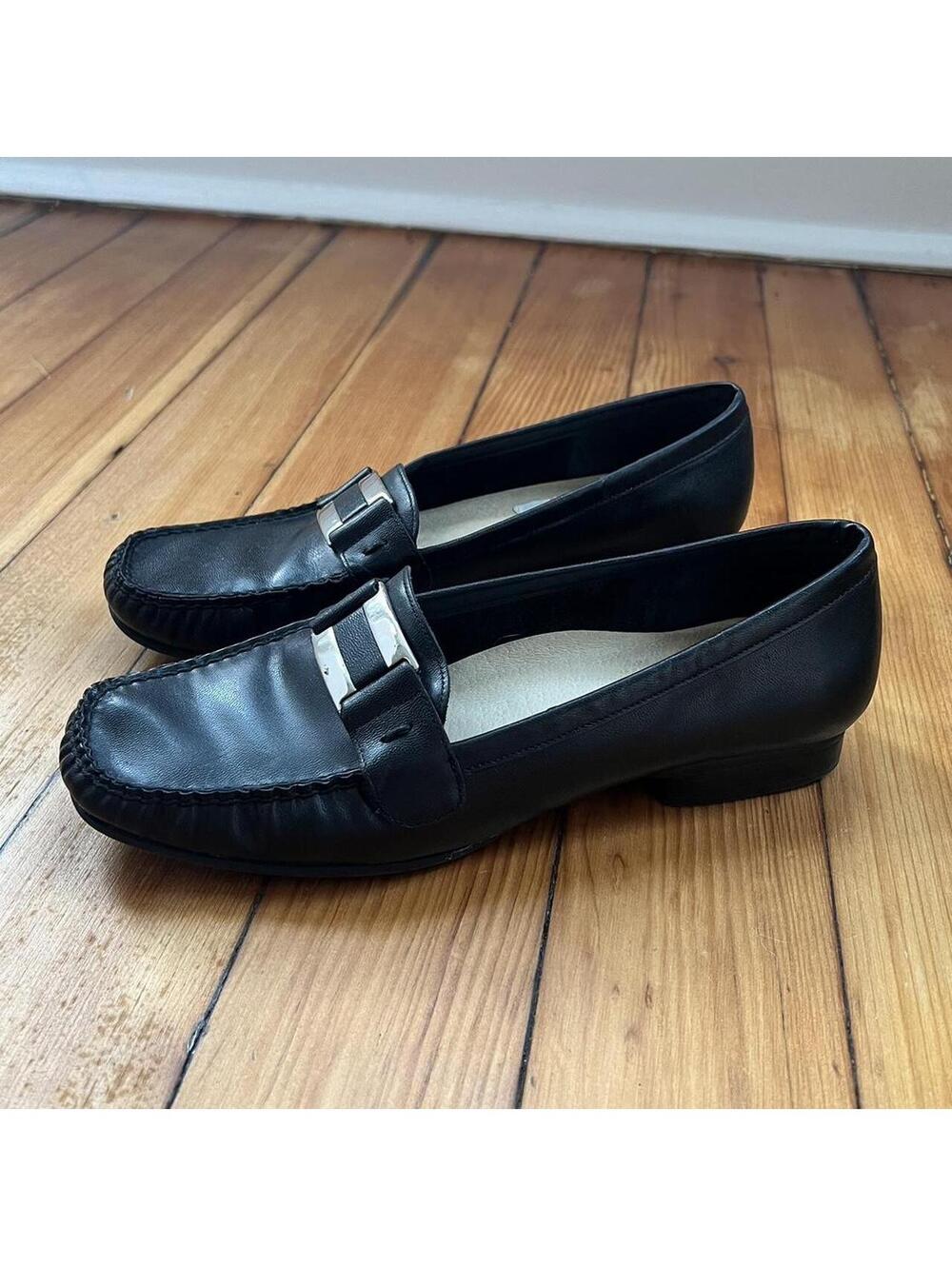 Black leather loafers with silver buckle detail